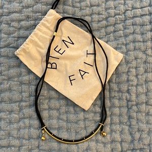 Madewell Marketplace Cord Necklace with brass colored metal pendant.